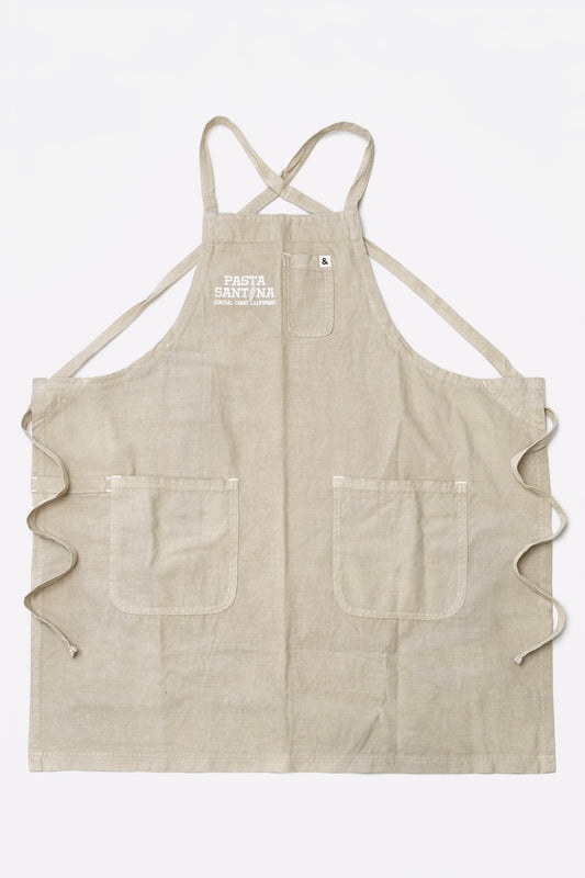 Beige crossback apron with a logo on a white background