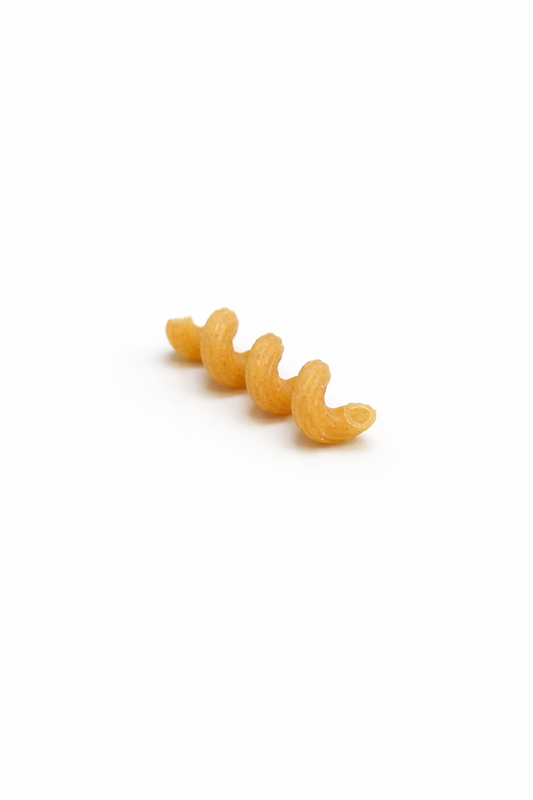Single piece of pasta on a white background, Spirali