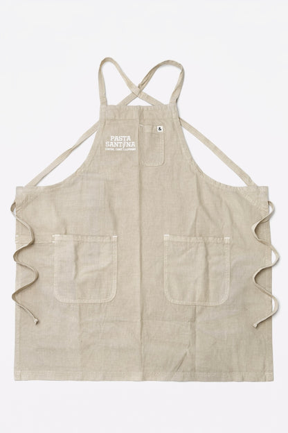 Beige crossback apron with a logo on a white background