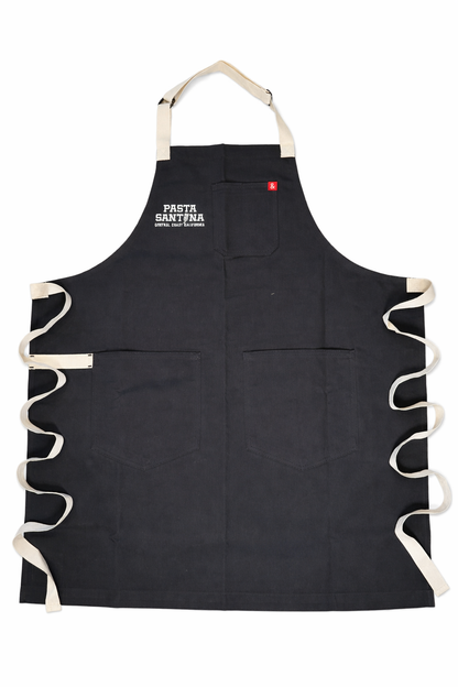 Charcoal colored apron with white straps on a white background