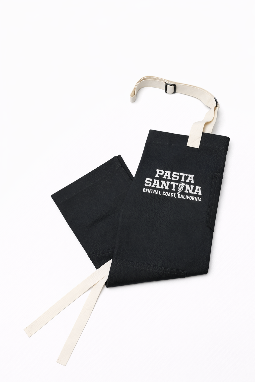 Charcoal colored apron with white straps on a white background, Folded