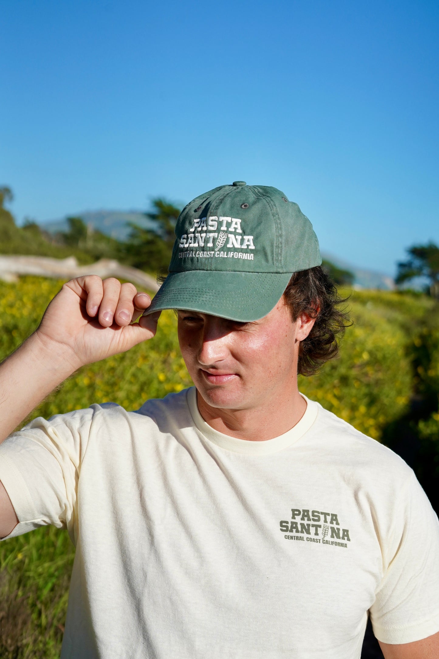 photo of model wearing Green colored baseball cap with a brown strap