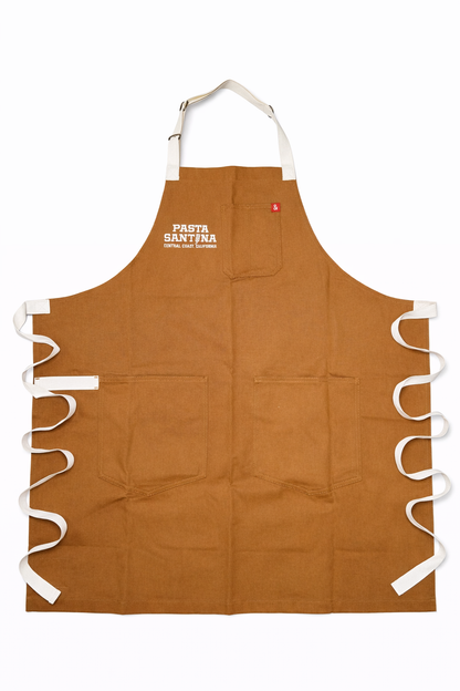 Khaki colored apron with white straps on a white background