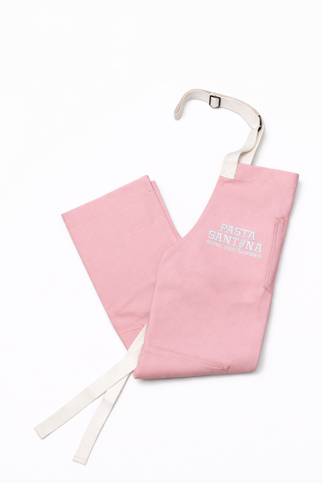 Pink Rose colored apron with white straps on a white background,Folded